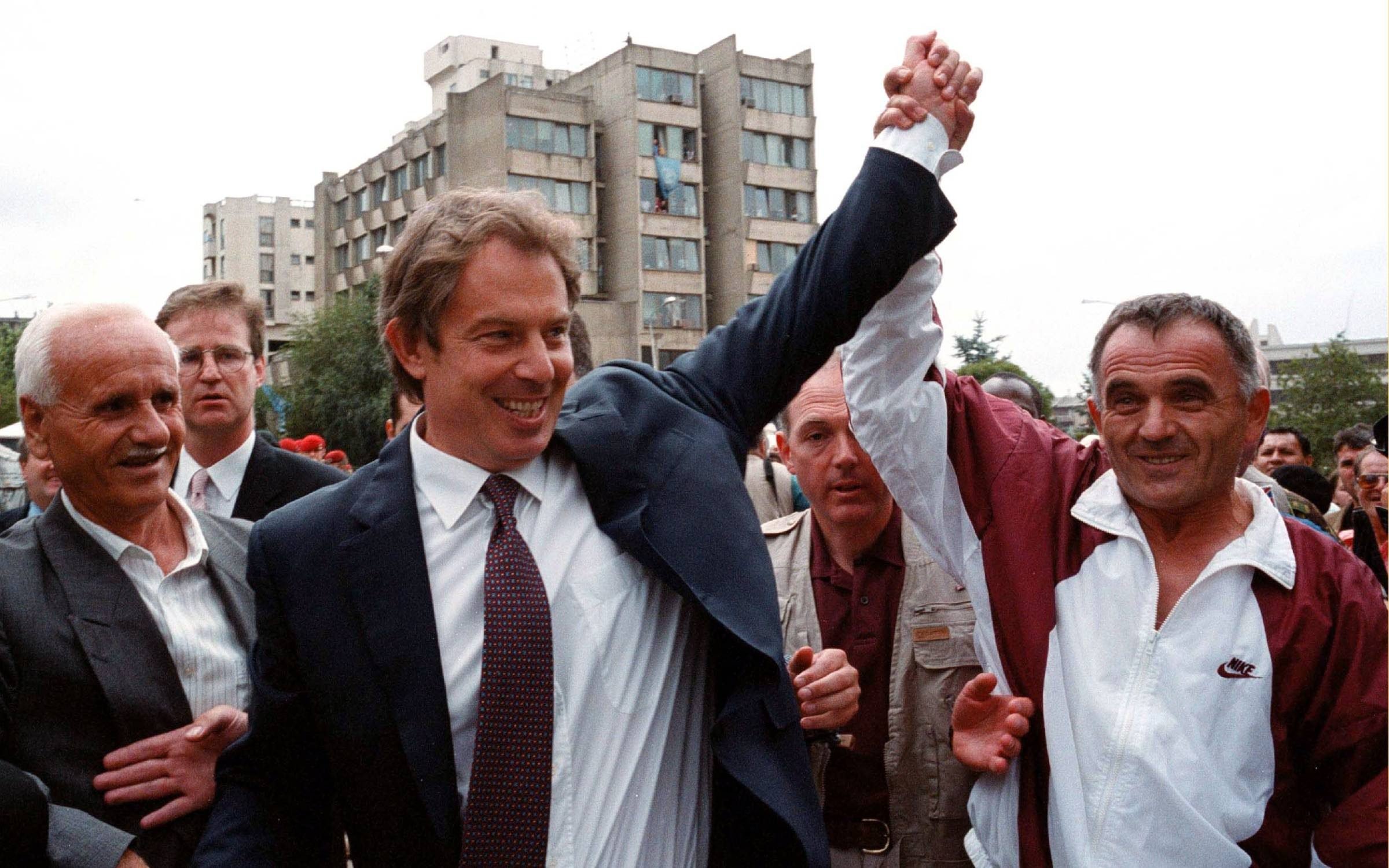 British Prime Minister Tony Blair greets an ethnic Albanian by holding up his hand in central Pristina, Yugoslavia during a one-day visit Saturday July 31, 1999. It was Blair's first visit to Kosovo since NATO's bombing campaign against Yugoslavia. (Photo by David Brauchli)