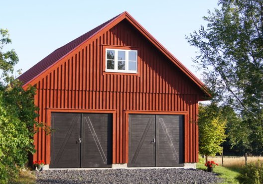 Barn style red exterior featuring black doors