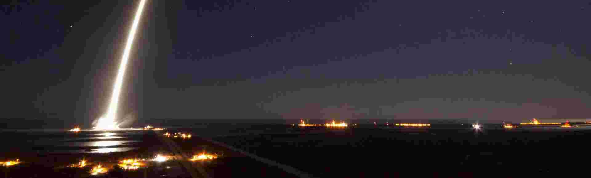 The SpaceX Falcon 9 rocket streaks across the night sky.