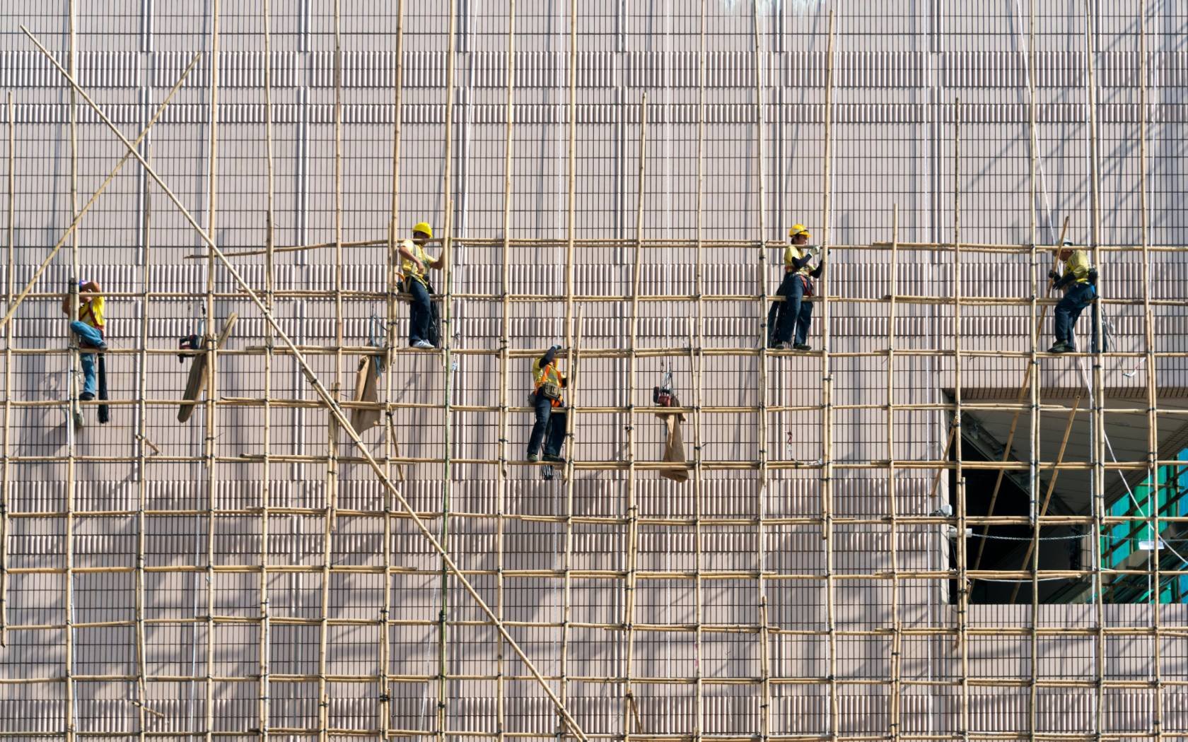 Construction workers on scaffolding in Hong Kong.