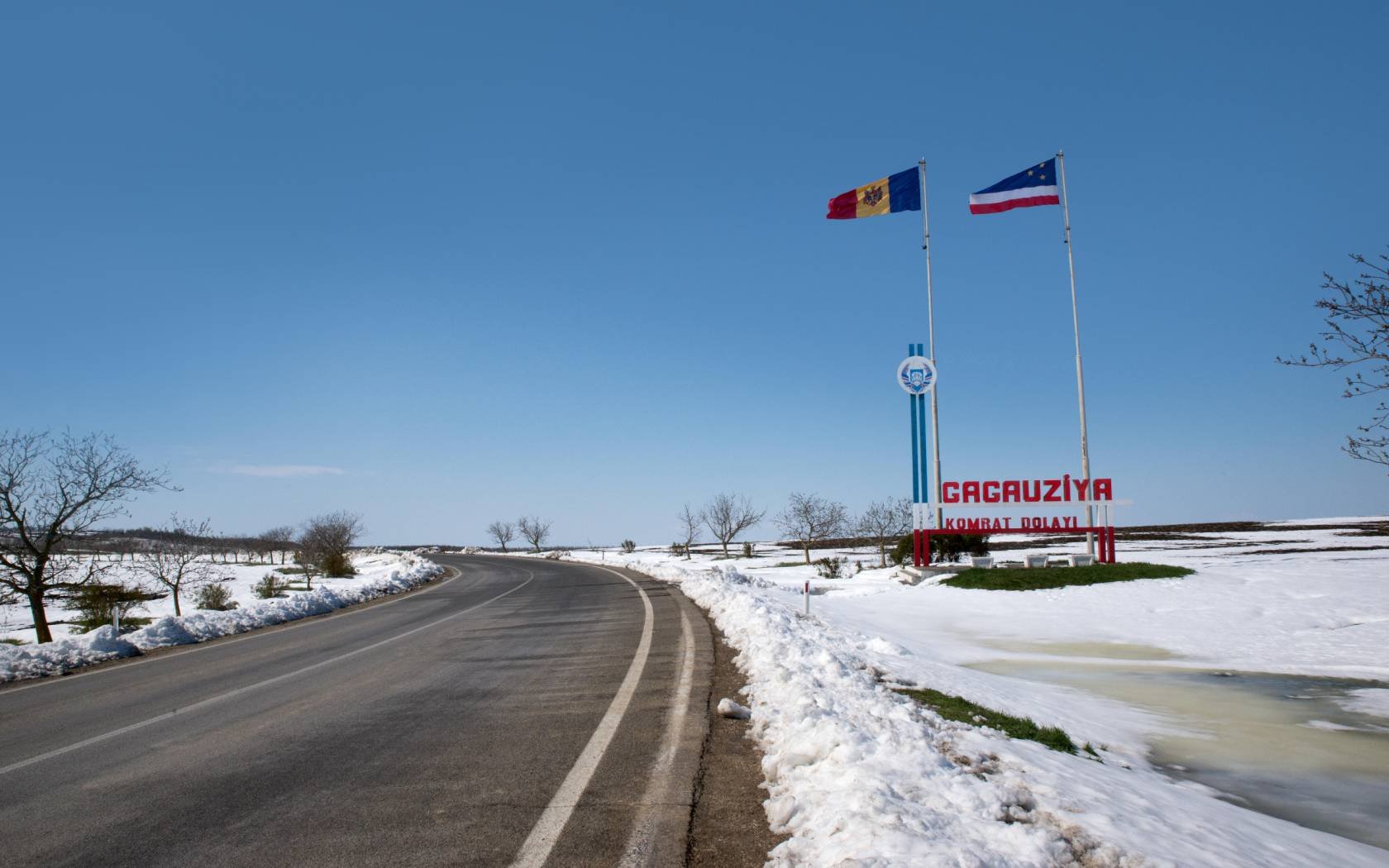 Moldovan and Gagauz flags fly at the 'Welcome to Gagauzia' sign at border of the autonomous region of Gagauzia.