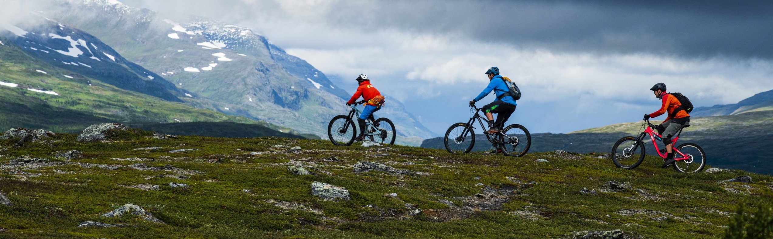 Mountain biker riding singletrack trail in Abisko with alpine mountain views