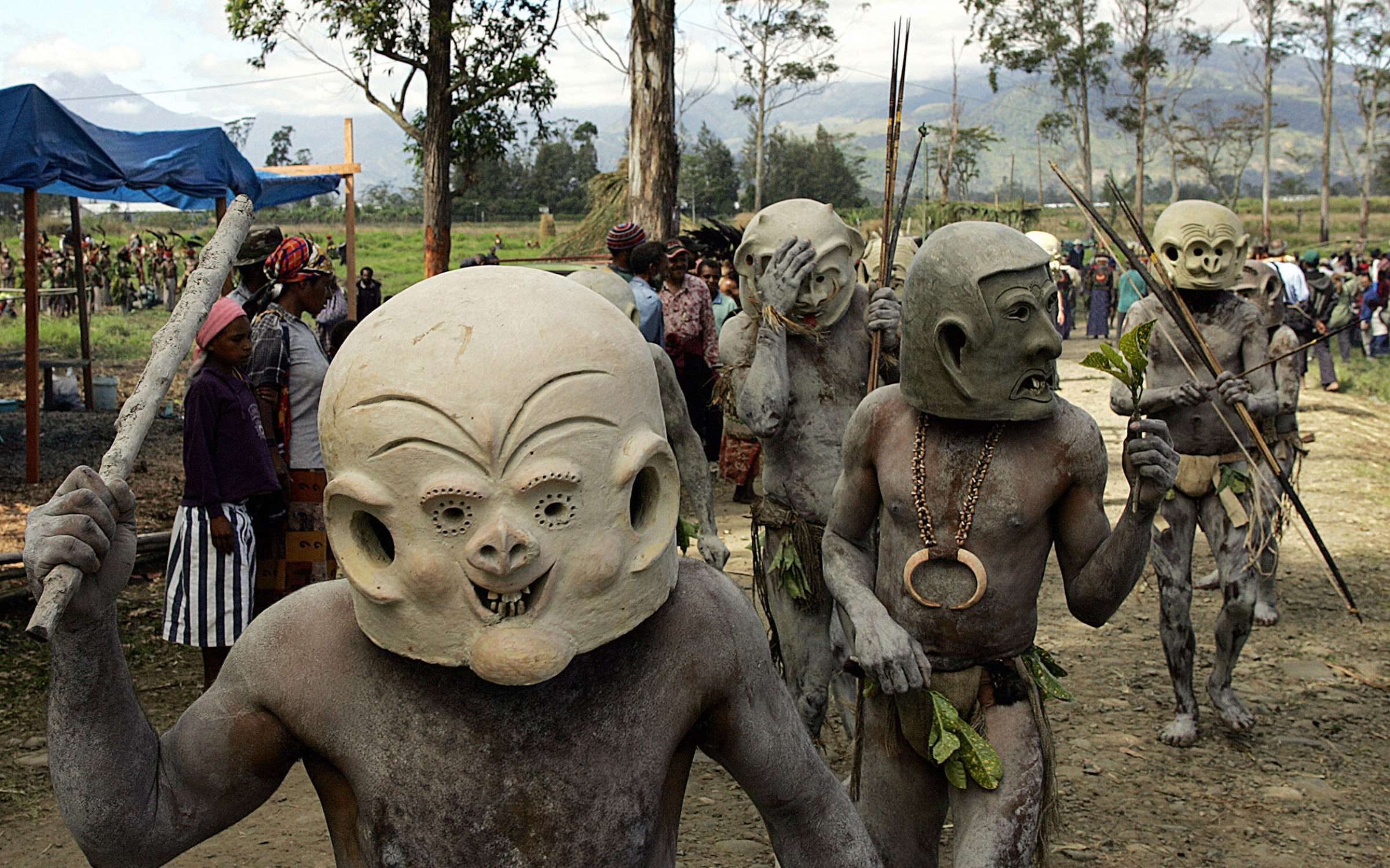 saro mud men from Goroka walk to the annual sing-sing cultural festival in Mount Hagen in 2004. Over 70 tribes put aside their ethnic tensions to come together once a year in the remote frontier town to celebrate the cultural diversity of Papua New Guinea. Credit: TORSTEN BLACKWOOD/AFP via Getty Images