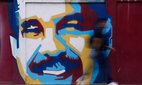 A pedestrian walks past a mural of Venezuelan President Nicolas Maduro Sunday, 4 January, 2026.