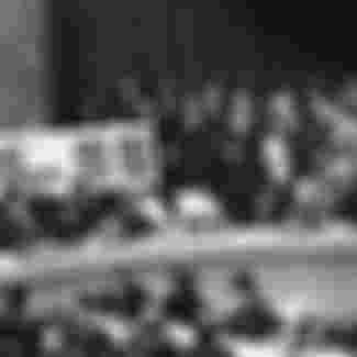 US Ambassador to the United Nations, Adlai Stevenson, second from right, confronts Soviet delegate Valerian Zorin, first on left, with a display of reconnaissance photographs during an emergency session of the U.N. Security Council at the United Nations headquarters in New York, on October 25, 1962.