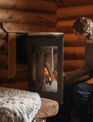 You put a log in the fireplace at Solhyllan in the Kåppa cottage village