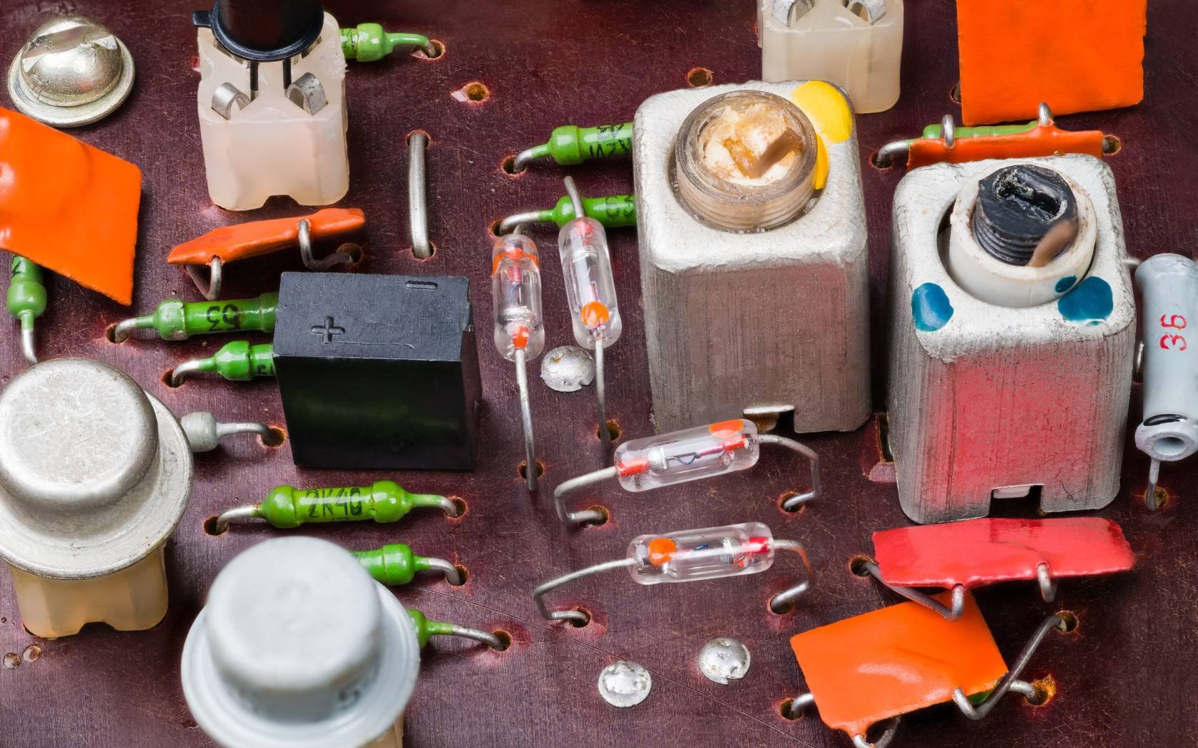 A retro circuit board with germanium transistors and diodes, electrolytic and ceramic capacitors, carbon resistors, aluminium coils. Credit: KPixMining / Alamy Stock Photo.