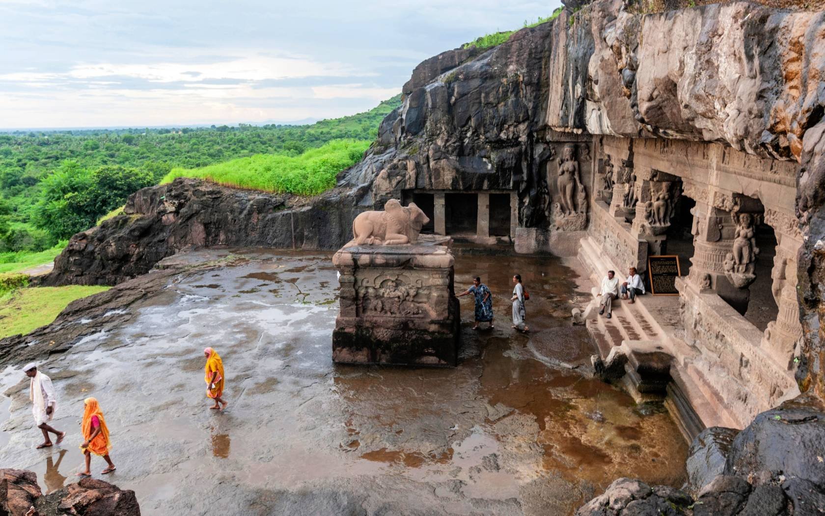 Visitors to the ancient Buddhist monastery in the Ellora Caves, Maharashtra, India.