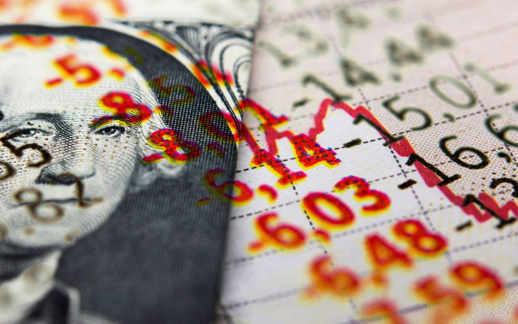 A US dollar bill next to declining economic figures.