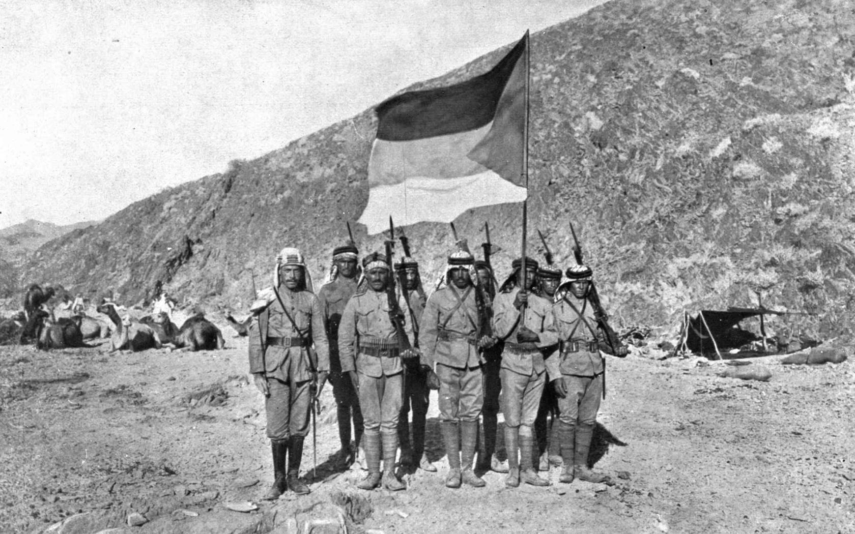 Arab soldiers carrying the flag of the Independent Kingdom of Hejaz, during the Arab Revolt, in 1917.