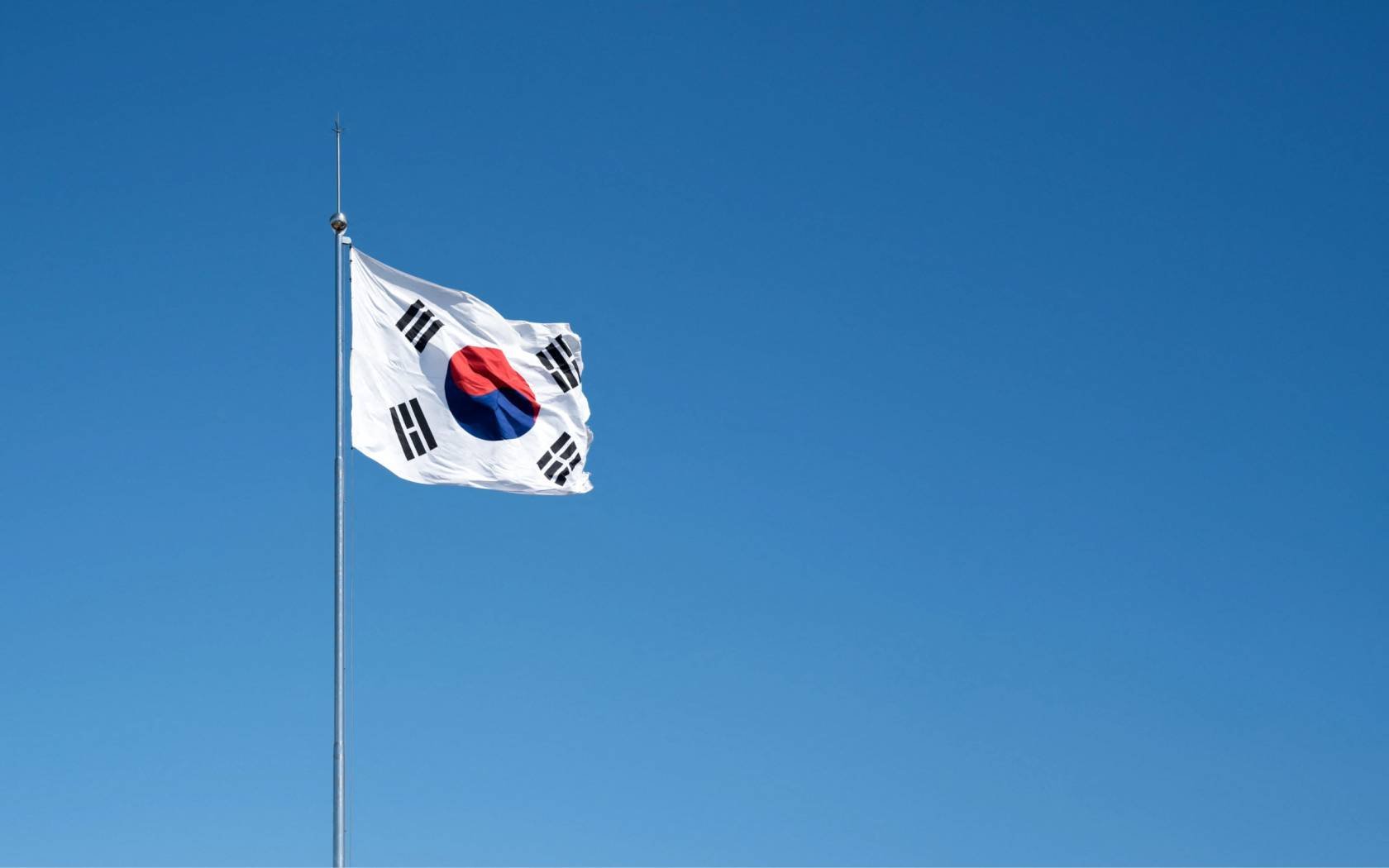 Flag of South Korea against a blue sky.