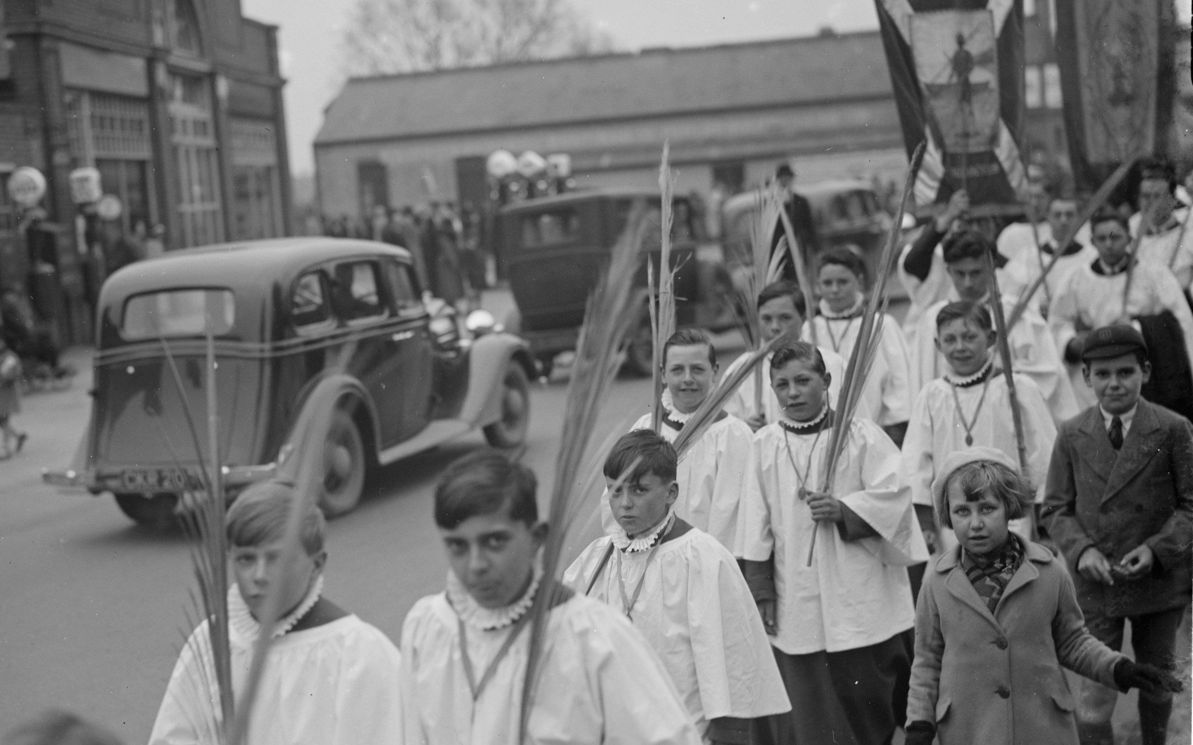 Choir boys carrying palm leaves in procession during Palm Sunday in 1936.