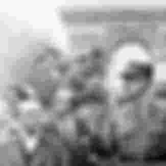 The President of France Charles de Gaulle marches through the streets under the Arc de Triomphe in 1944.