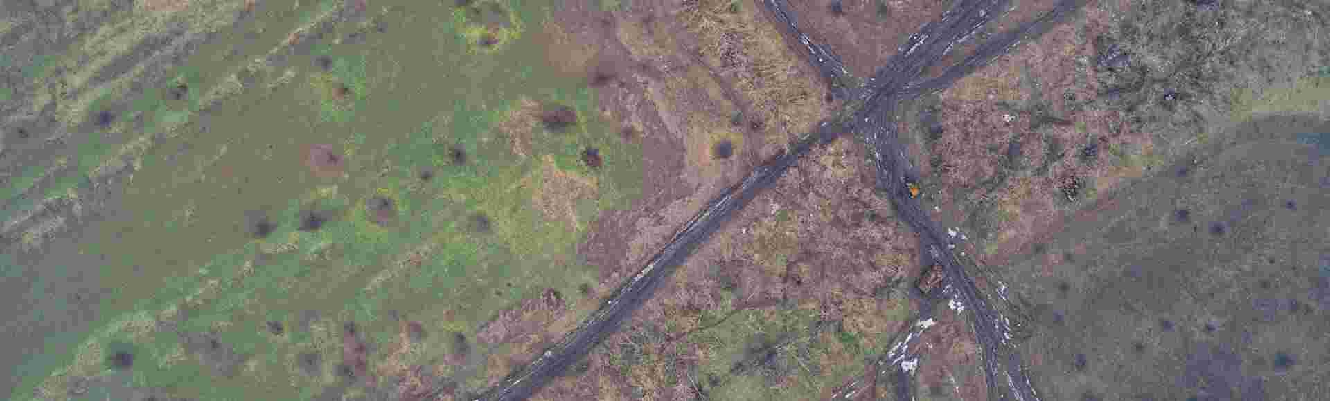An artillery-cratered crossroads in Donbas.