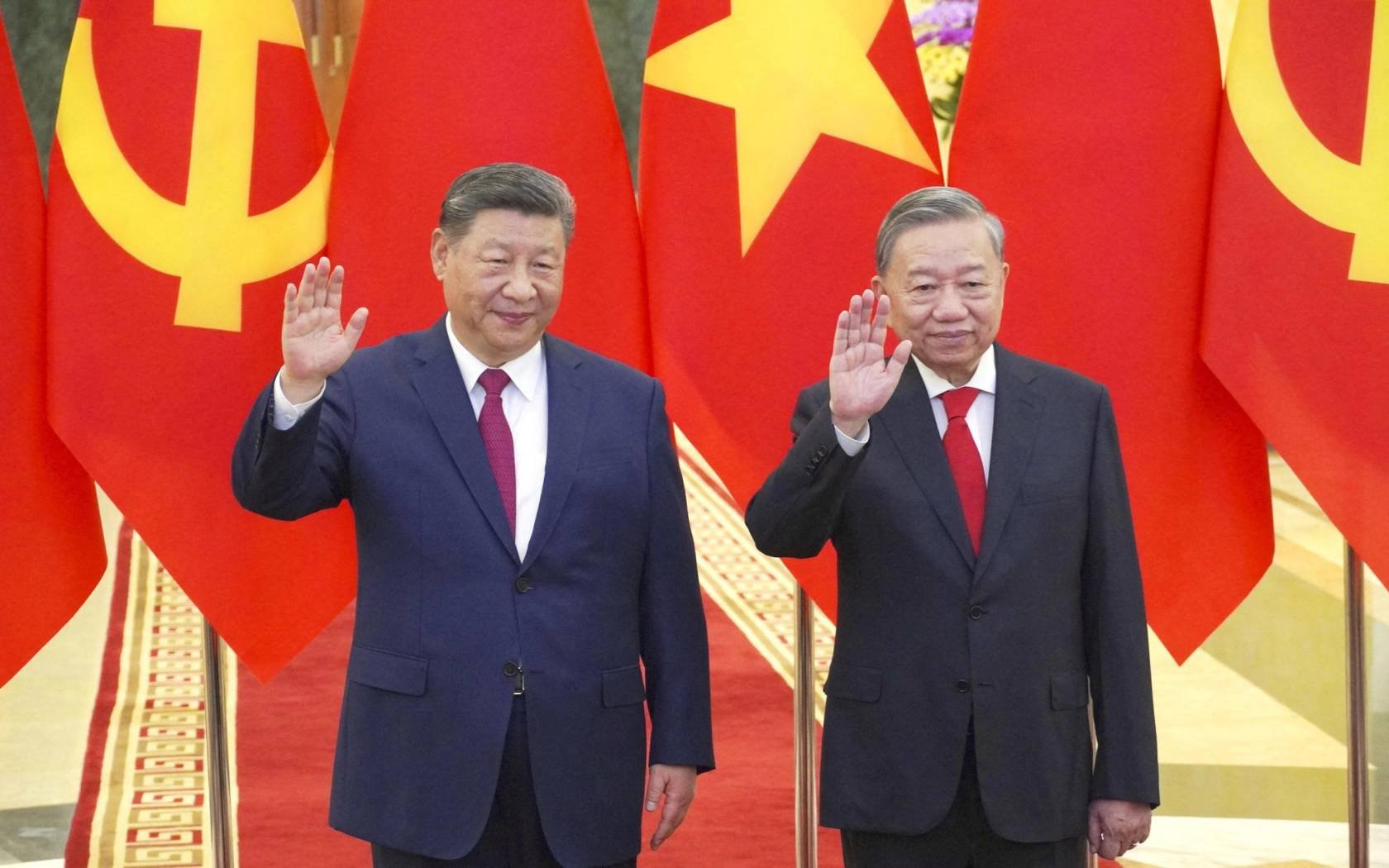 Chinese President Xi Jinping and Vietnamese President To Lam wave in Hanoi on April 14, 2025.