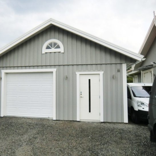 Unique side by side garage and pedestrian door with arc window above