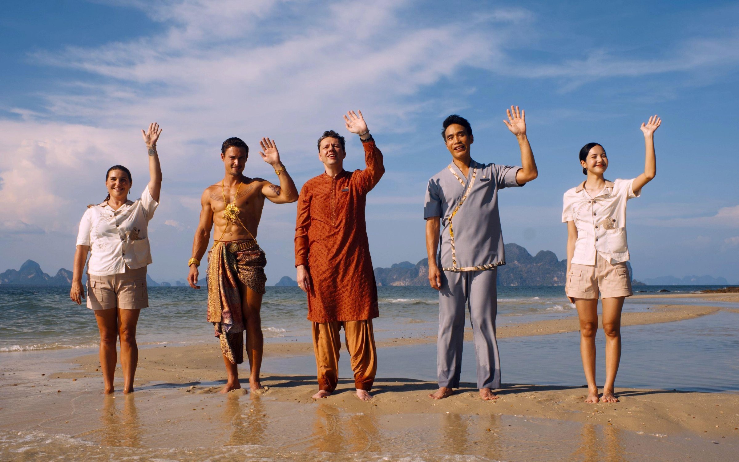 The hotel staff from the third season of HBO's White Lotus wave to arriving guests on a beach in Thailand's Koh Samui.