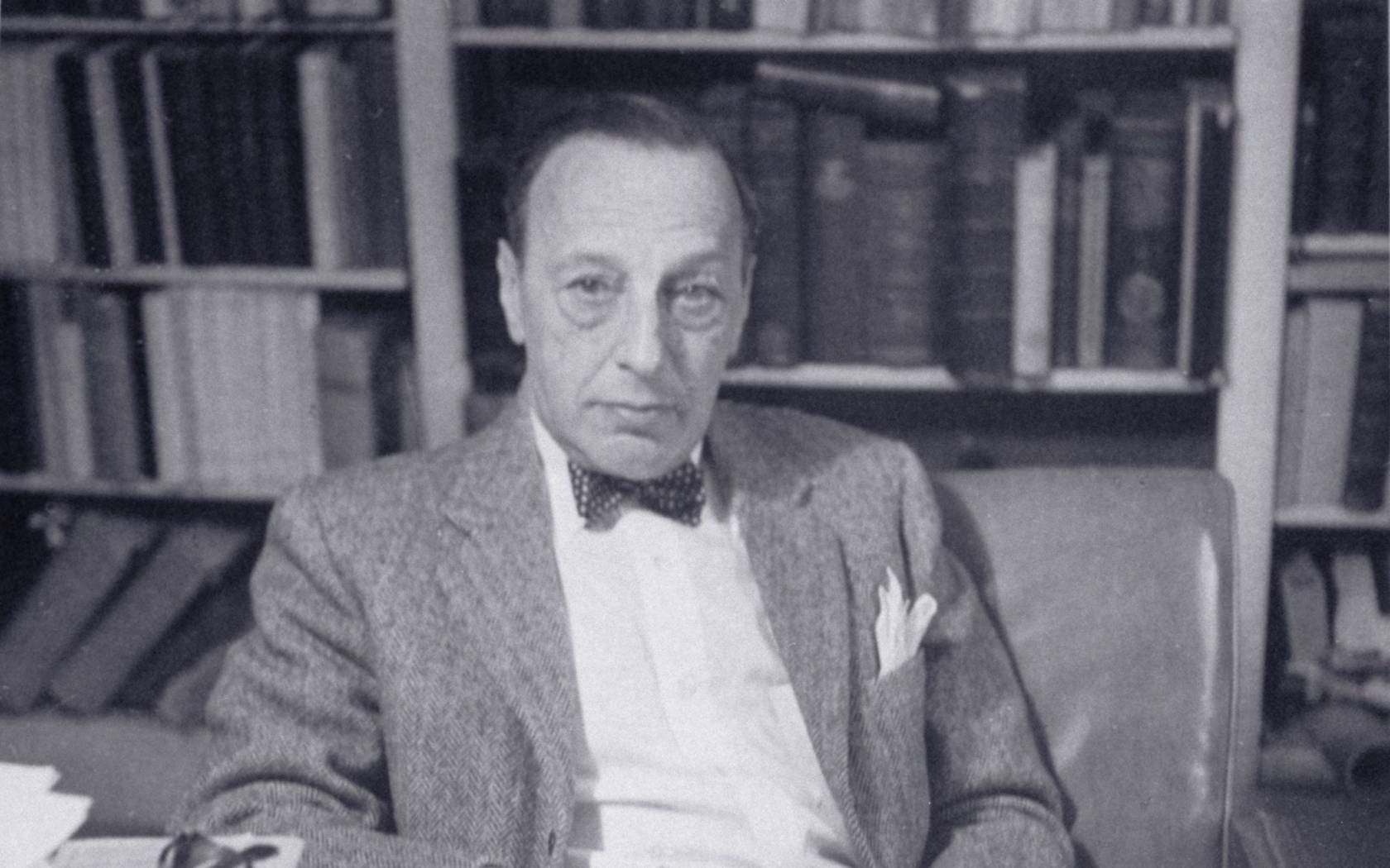 Ernst Kantorowicz seated at his desk, photographed and signed by Trude Fleischmann. Credit: Leo Baeck Institute, F 3891F.