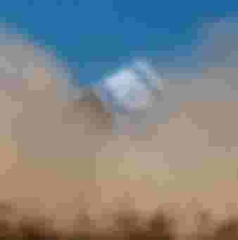An Israeli flag is seen through a dust cloud near the border with the Gaza strip.