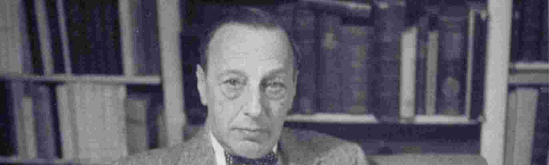 Ernst Kantorowicz seated at his desk, photographed and signed by Trude Fleischmann. Credit: Leo Baeck Institute, F 3891F.