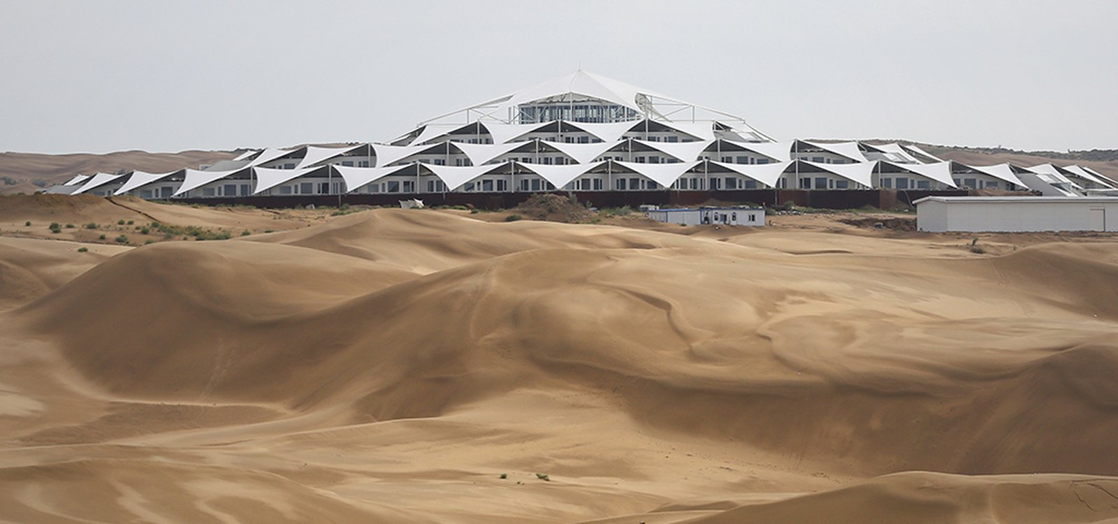 <p>The hotel sits in the middle of the desert, but close to China’s rare earth miners.</p>
