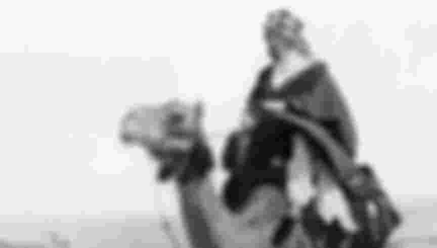 Thomas Edward (of Arabia) Lawrence riding a camel