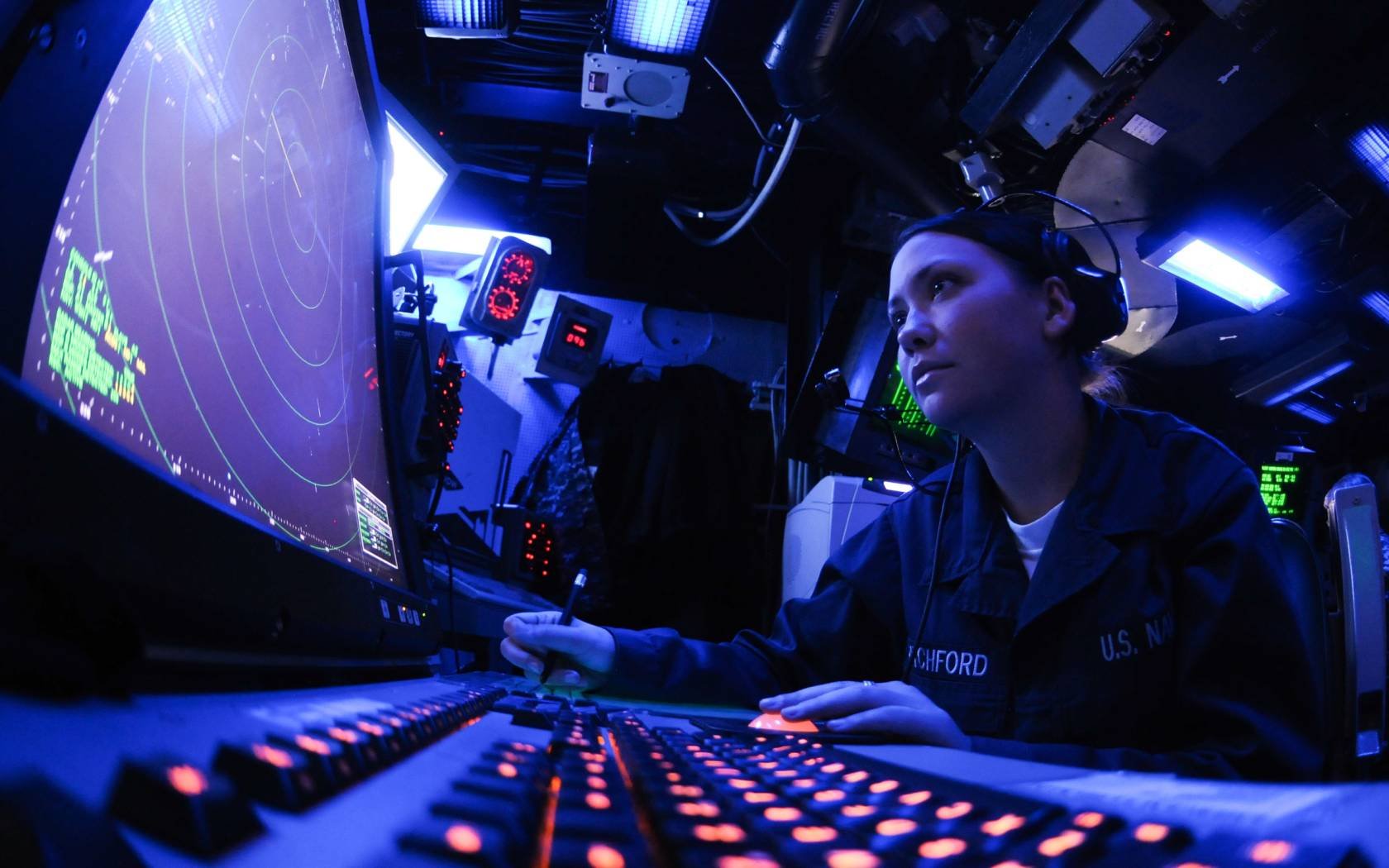 U.S. Navy Air Traffic Controller Airman monitors an air approach radar console