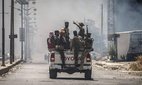 Bedouin and tribal fighters gather in a vehicle in the city of Suwayda.